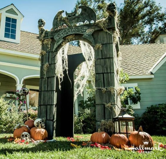 crypt gateway decorated with pumpkins, skulls, lanterns and spiderweb