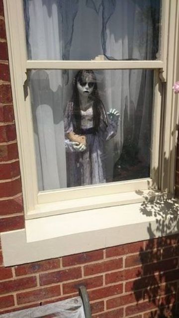 scary child standing by the window is a cool and frightening idea