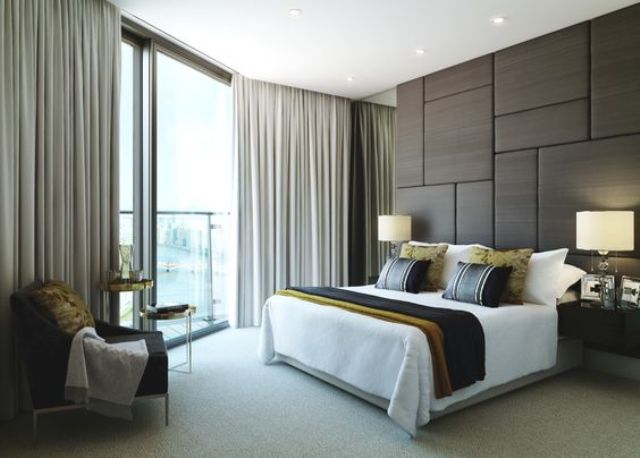 upholstered panel wall makes this bedroom modern and chic