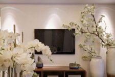 23 white orchids and white silk cherry blooms give a Chinese feel