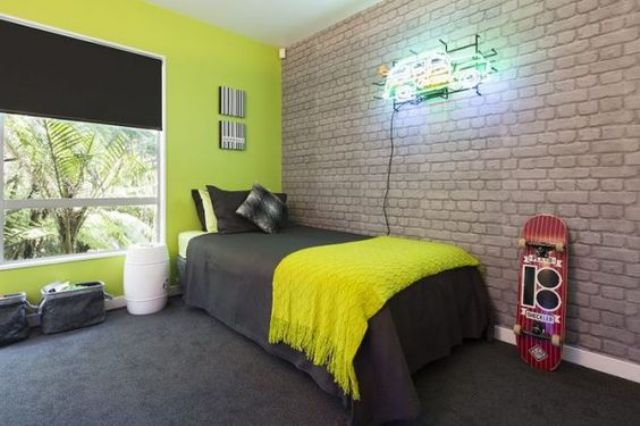 exposed brick highlights that it's a boy's room and contrasts with neon