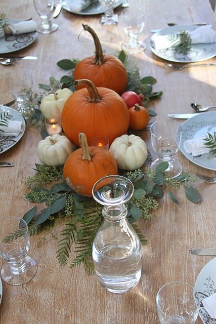 natural pumpkins with greenery and leaves placed right on the table