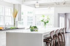 24 rustic kitchen design is modernized with a sleek white waterfall countertop