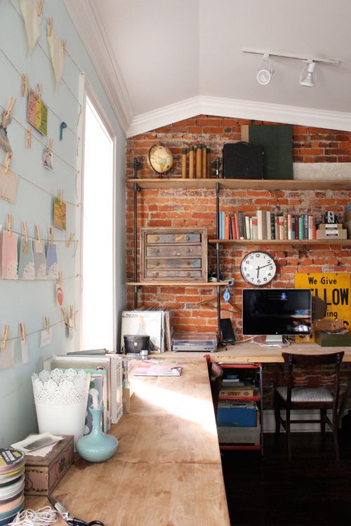 simple exposed red brick blends perfectly with this industrial office