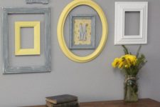 25 cream, grey and yellow frames on a light grey wall