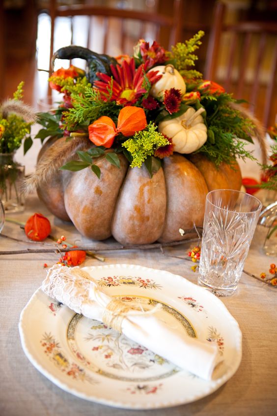 pumpkin vase with faux flowers, pumpkins and fir branches