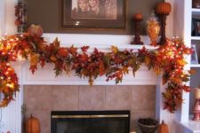 25 use a fall leaf garland to decorate your fireplace