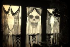 25 use black cheese cloth as spooky yet classy curtains for Halloween decorations