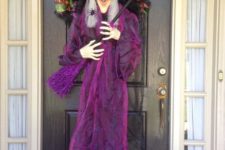 26 door wreath with a whole witch doll in purple