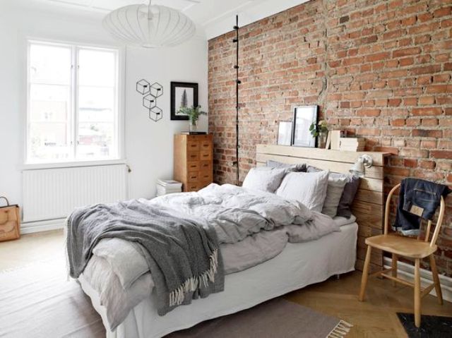 vitnage-inspired bedroom is accentuated with an exposed brick wall