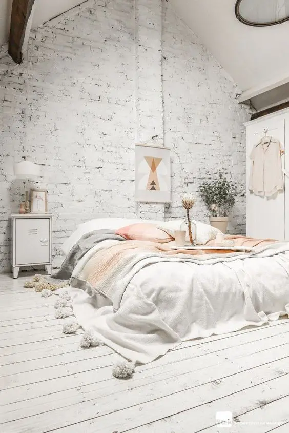 airy white bedroom with whitewashed brick to make it more original-looking