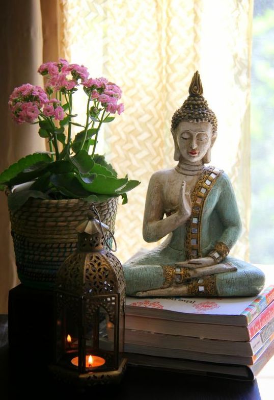 Buddha, a hand mudra and an unpretentious orchid bring a zen feel