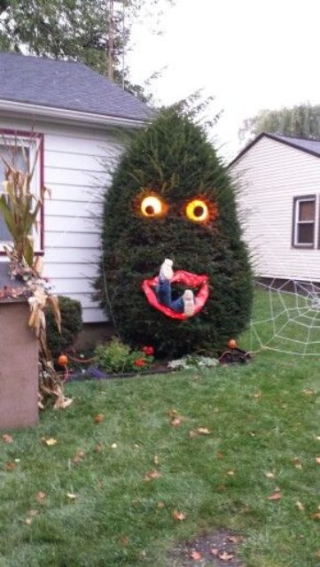People eating Halloween tree with lighted eyes