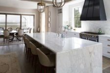 29 enjoy the durability of marble using it not only for a waterfall countertop but also for backsplashes