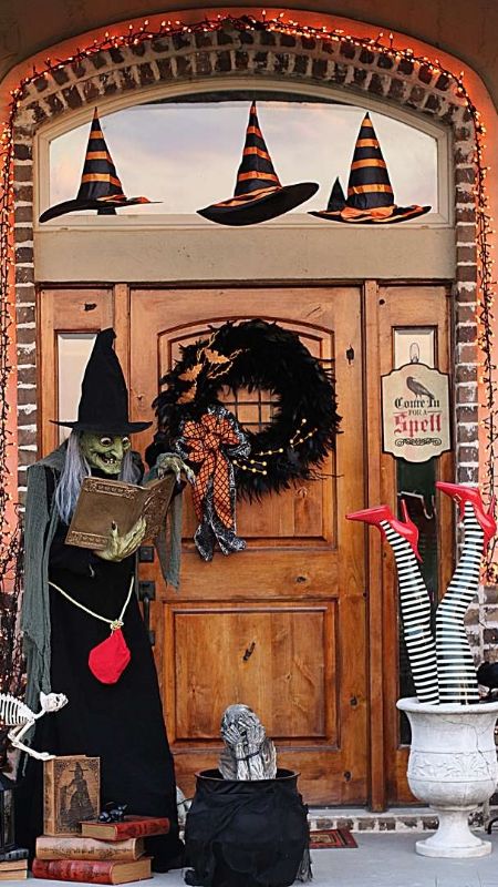 witch with a cauldron at the door to welcom guests