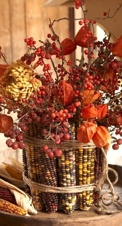 corn tied up with twine, flowers and berries