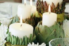 32 dish centerpiece with candles covered with artichokes, asparagus and peas