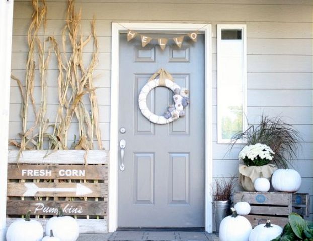 neutral fall decor, white pumpkins, corn stalks, vintage farm house signs, a fabric wreath, burlap bunting