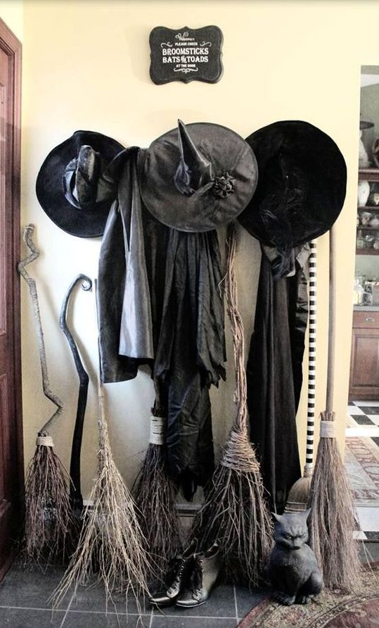 witches' gowns, hats and brooms in the entryway