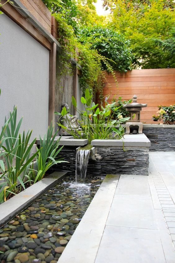 a garden waterfall can be spruced up with pebbles to look more Asian-like