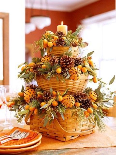 tiered centerpiece of baskets with pomanders, pinecones and fir branches