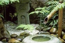 36 traditional Japanese bamboo fountain and large pebbles around