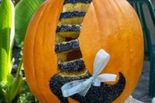 40 witch leg with glitter and a bow on a pumpkin