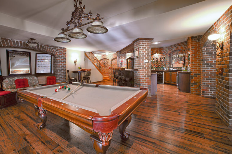 a game room and a bar are perfect additions to any basement and brick walls are a must there for a cool industrial vibe (M.J. Whelan Construction)
