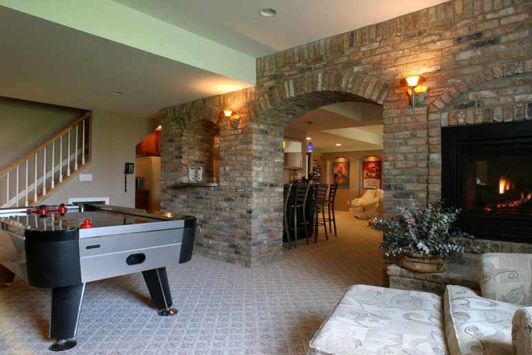 a billiard room with a fireplace should definitely feature a brick wall
