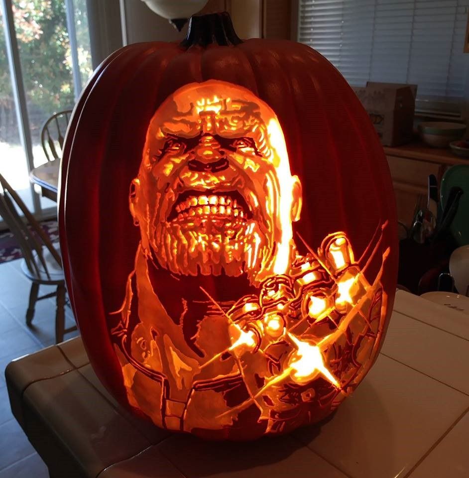An amazing Thanos pumpkin carving with all infinity stones that are glowing