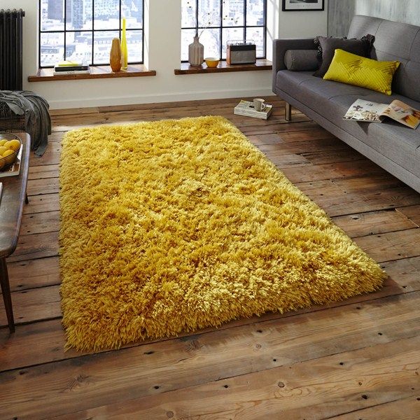 A bright yellow shaggy rug would look well by a grey sofa.