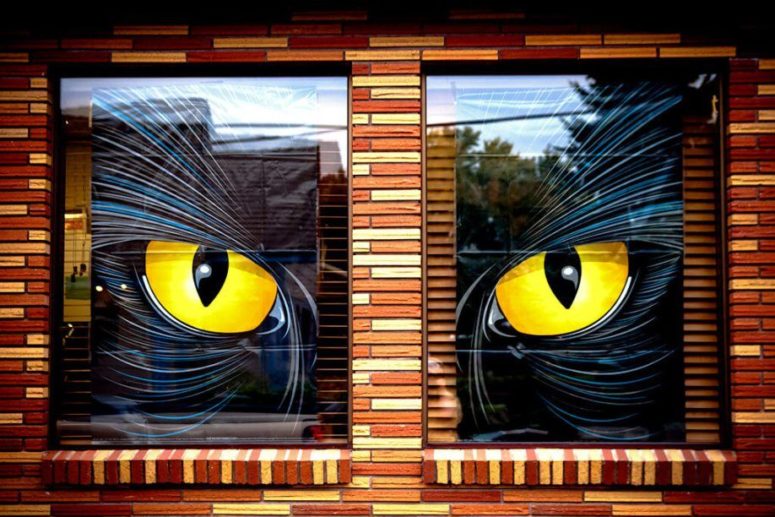 a large watching monster is a perfect way to decorate two windows that are close by