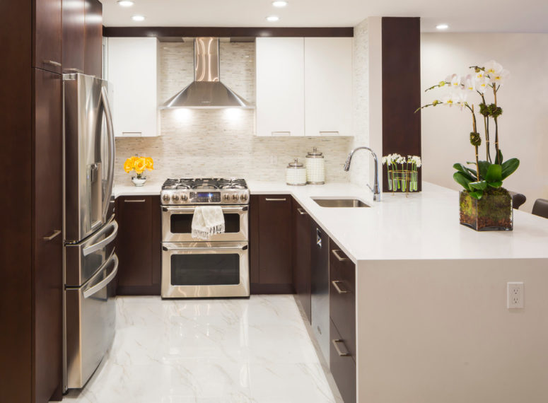 a waterfall countertop makes the whole kitchen looks less bulky (Vi-Design)