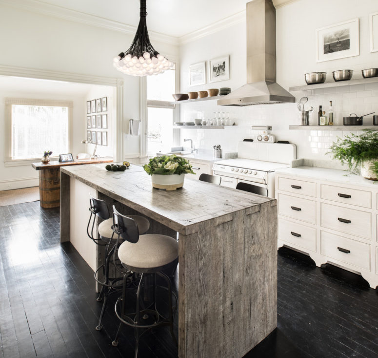 a reclaimed kitchen island adds a rustic flair to a contemporary kitchen (Antonio Martins Interior Design)