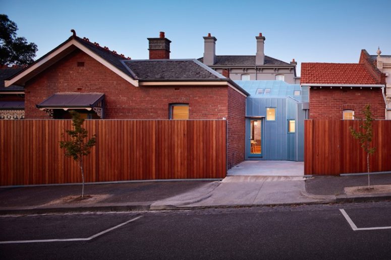 This brick family home in Melbourne was connected with a modern glazed extension