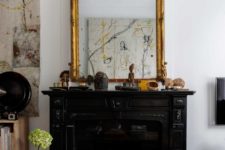 02 Every space in the house has a black vintage fireplace with an oversized mirror