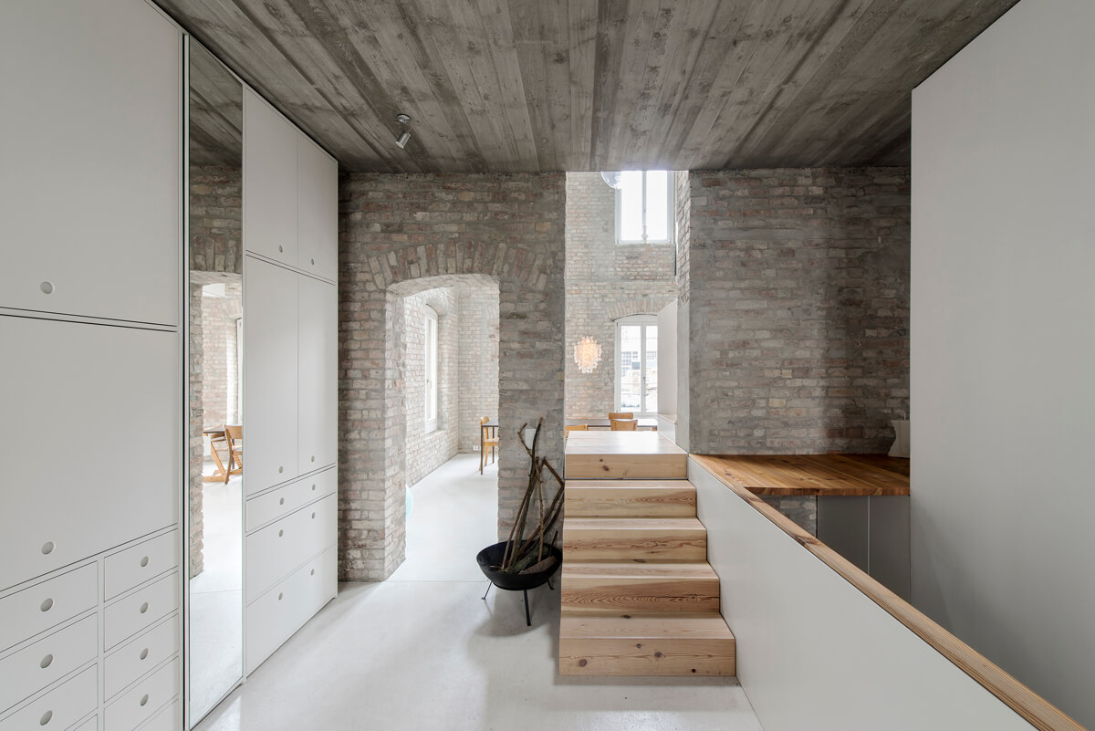 Historic brick walls are left untouched, and the ceilings are wooden, the rooms are spacious with double height ceilings
