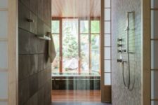 02 Japanese-styled bathroom in dark earthy colors, with a rain shower and wood floor