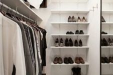 02 perfect minimalist closet layout with a leading rack on one wall, a mirror on the opposite wall and shoe shelves on the third one