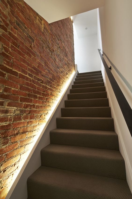 LED lights hidden in the brick wall to line up the stairs