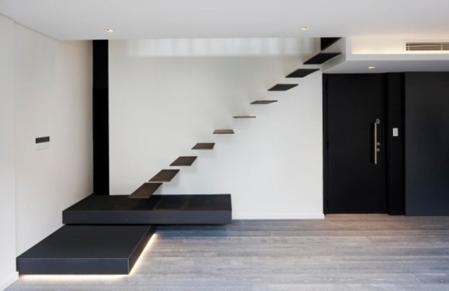Simple black and white color scheme is enlivened with lighting