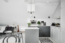 03 The kitchen is modern, with grey and white cabinets and greenery to enliven the look