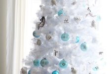03 crispy white christmas tree decorated in blue and silver breathes with frost