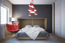 04 The bedroom is highlighted with red pendant lamps and a soft modern chair