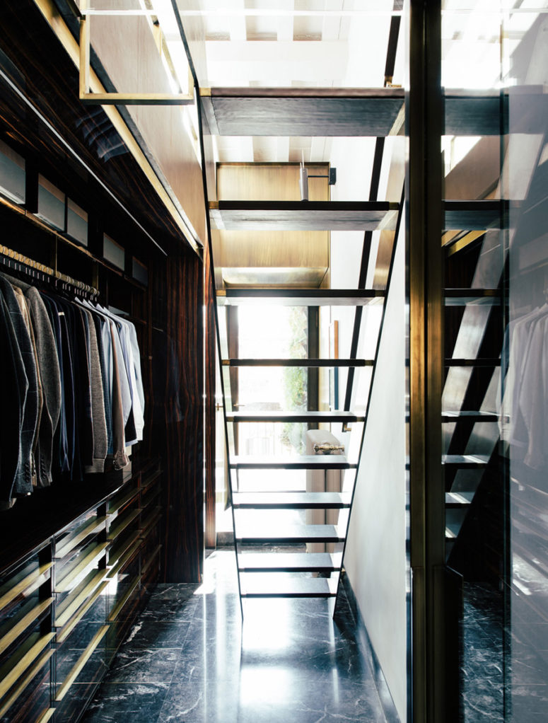 The closet is hidden downstairs, it's elegant, light-filled and with bold brass accents
