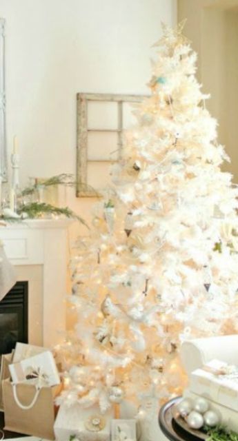 elegant Christmas tree with silver ornaments and a gold topper