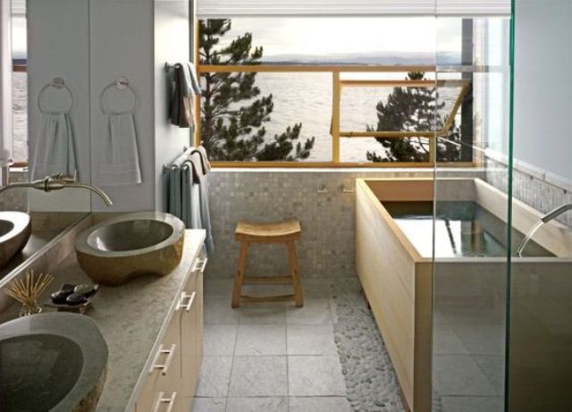 light Japanese bathroom with stone sinks, a wooden bathtub, light tiles and stone
