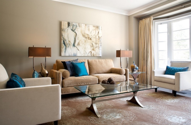 eclectic lviing room in calm brown shades with a couple of bold blue pillows