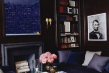 05 navy living room with a faux fireplace and a navy mirror over it