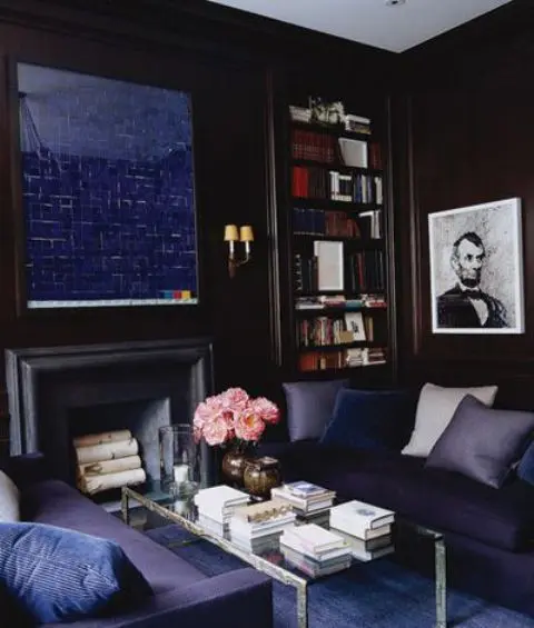 navy living room with a faux fireplace and a navy mirror over it